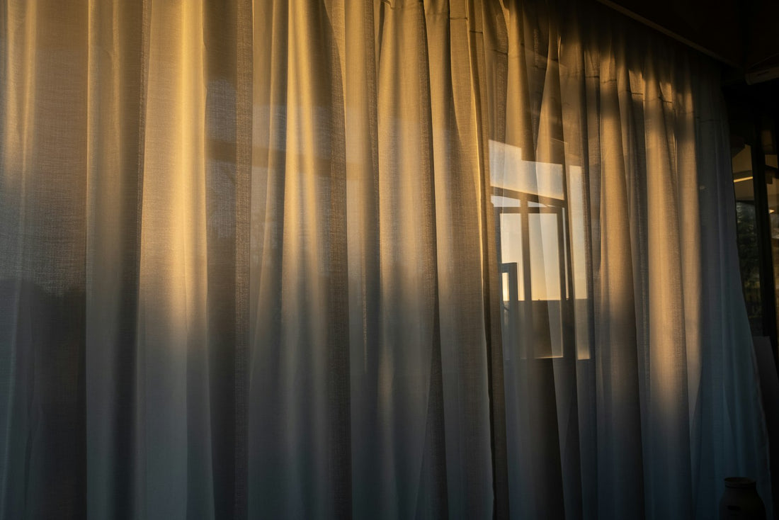 Neutral shower curtain hanging in a bright bathroom