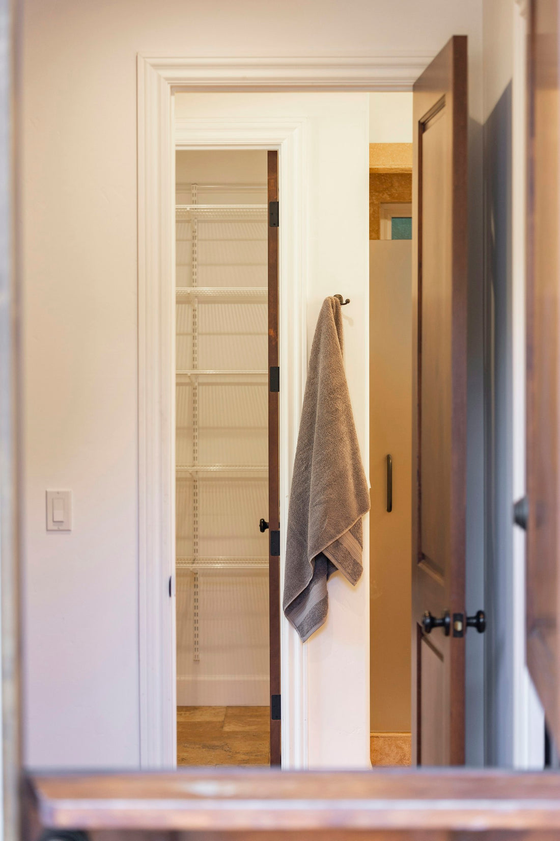 Organized linen storage with folded towels and bathroom shelving